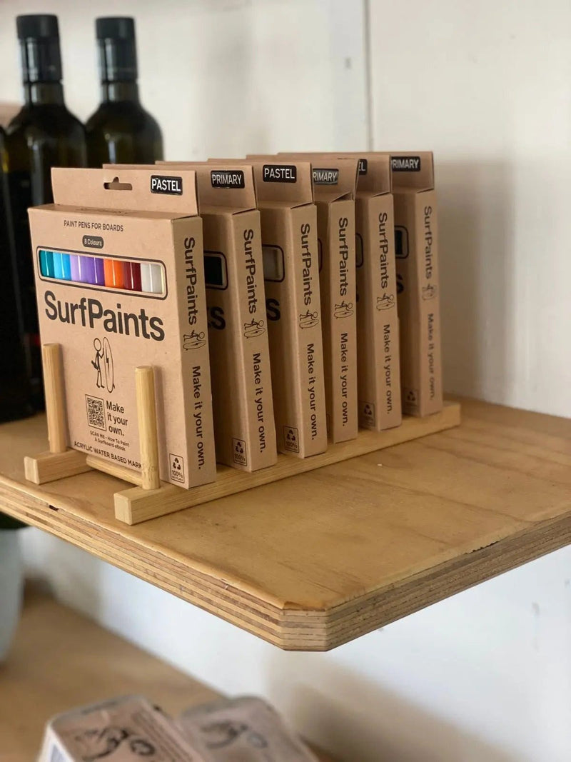 Surfpaints 8-packs on a bamboo counter display stand